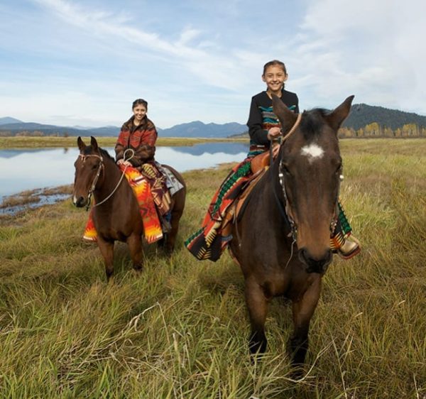 Two Kalispel Tribal members on horseback.